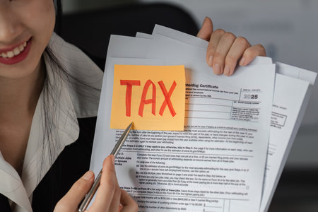 Accountant detailing tax documents, emphasizing important financial aspects.の写真素材