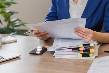 Accountant reviewing tax documents at a desk, preparing for IRS filing.