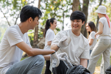 Two young men smiling while participating in a community cleanup eventの写真素材