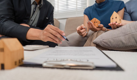 Real estate negotiation. Professionals outlining contract terms for home purchase.