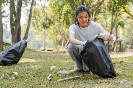 Active Participation. Volunteer collecting trash in a park.の写真素材