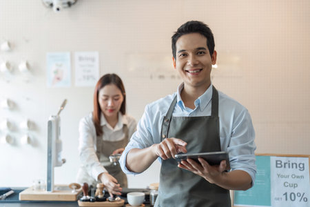 Sustainable Practices and Barista Skills. A barista cheerful while showcasing sustainable practices in the coffee-making process.の写真素材