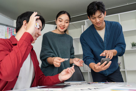 Collaborative Design Review. Team members actively sharing design pieces and ideas while analyzing user experience.の写真素材