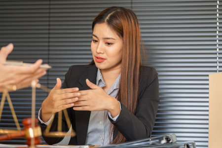 Legal Engagement and Client Discussion. A lawyer presents case arguments to the client with...