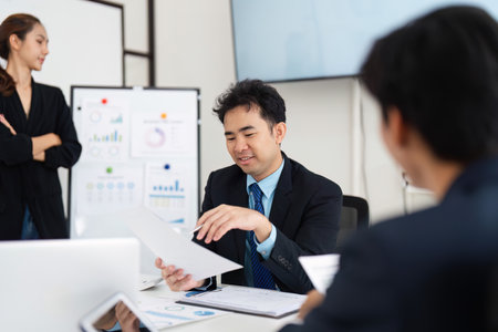 Effective Leadership and Team Collaboration. A manager guiding team discussions in a strategic meeting.の写真素材