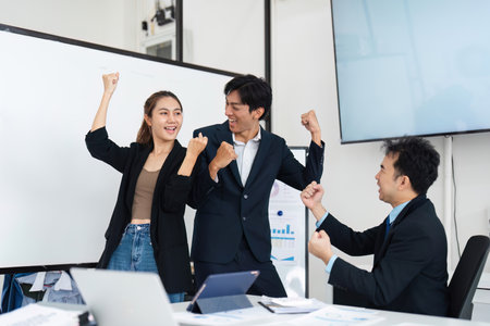 Victorious Teamwork and Enthusiasm. Colleagues celebrating their success and demonstrating team spirit.の写真素材
