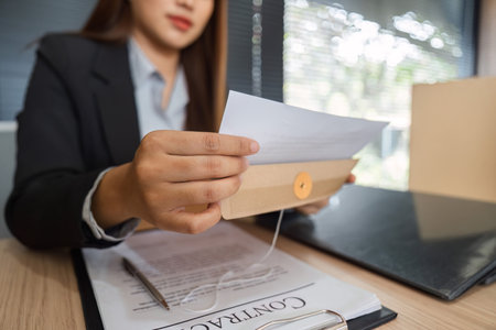 Legal Analysis and Document Management. Lawyer reviewing critical legal papers for future endeavors.の写真素材