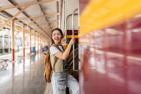 Traveling and Exploration. A young woman smiles while boarding a train with her camera in hand.