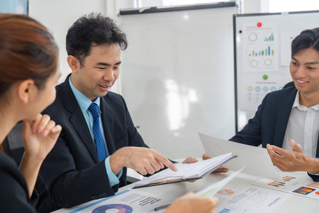 Engagement and Strategy. A focused team working through project performance metrics collaboratively.の写真素材