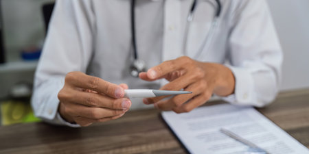 Examining Health Tools. A doctor explaining medical tools during a patient consultation.の写真素材