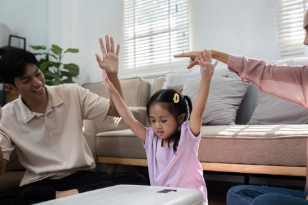 Joyful Anticipation and Family Interaction. A playful family shares laughter and excitement as they prepare for their upcoming adventure together.の写真素材