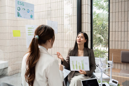 ESG Strategies and Dialogue. A professional discussion about ESG metrics and sustainable growth, featuring visual data charts.の写真素材