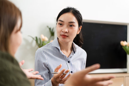 Therapeutic Conversation and Insight. A psychiatrist engaging in a meaningful dialogue with a client.の写真素材