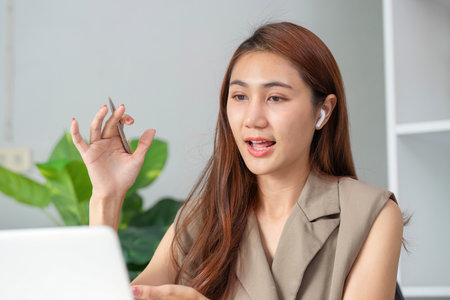 Effective Communication and Presentation. A woman articulates her points during a virtual meeting with emphasis.の写真素材