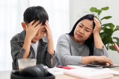 Challenges and Support. A mother comforts her son who is feeling frustrated while studying at home.