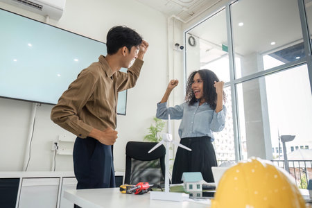 Teamwork and Sustainability. Celebrating success in a sustainable housing project.の写真素材
