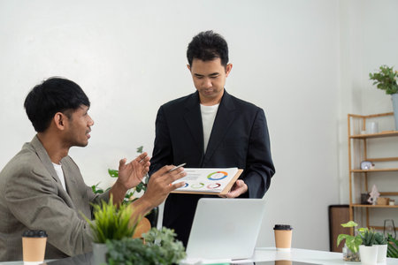 Business Presentation and Analysis. A professional presenting data insights during a meeting.の写真素材