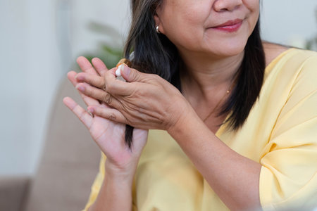 Nourishing Hair and Beauty. A woman applying hair serum for healthy locks.の写真素材