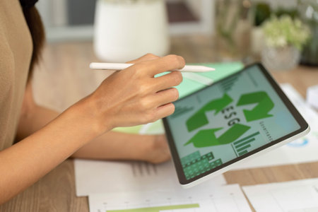 ESG sustainability planning using tablet and environmental modelsの写真素材