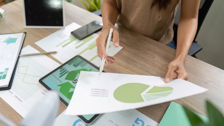 Sustainability assessment with woman analyzing data during presentationの写真素材