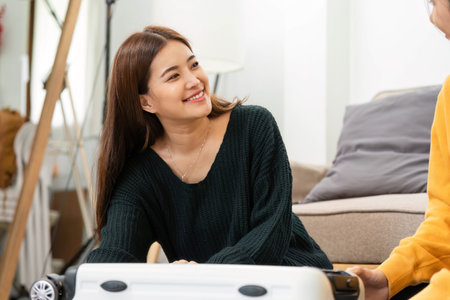 Wellness and friendship: Young women bonding while packing for a tripの写真素材