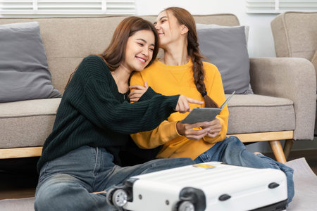 Wellness and togetherness: Women cuddling while reviewing travel detailsの写真素材