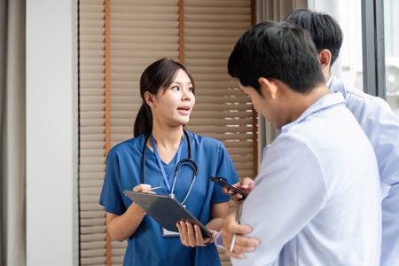 Doctor discussing patient care with colleagues in a modern clinicの写真素材