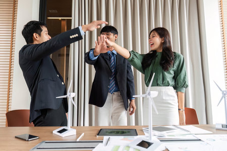ESG Initiative: Team celebrating with high-fives for sustainability