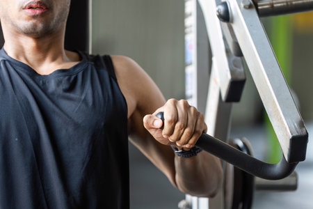 Fitness Training with Resistance Equipment. Close-up of a man exercising with gym equipment.の写真素材