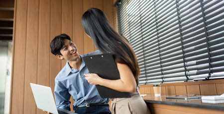 Business Communication and Strategy. Engaged professionals sharing insights in a collaborative office environment.の写真素材