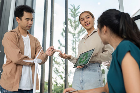 ESG and Sustainability. Team discussing eco-friendly business strategies in modern office.の写真素材