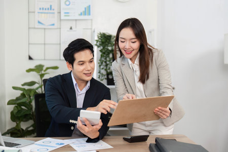 Financial Success. Colleagues celebrating achievements in a modern office.の写真素材