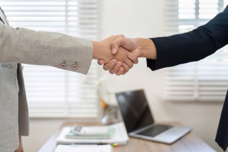 Professional Agreement and Partnership. Business people shaking hands in office environment.の写真素材