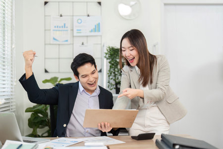 Business colleagues celebrating success in a modern office.の写真素材