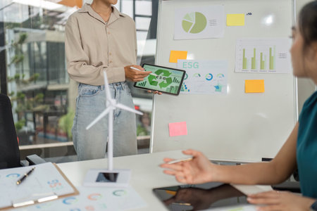 ESG Initiative Presentation. Woman showcases sustainability goals in a business meeting.