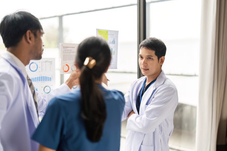 Teamwork in Healthcare: Doctors analyzing patient data chartsの写真素材