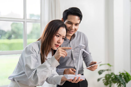 ESG and Business Innovation. Engaged professionals exploring renewable energy solutions in a modern...