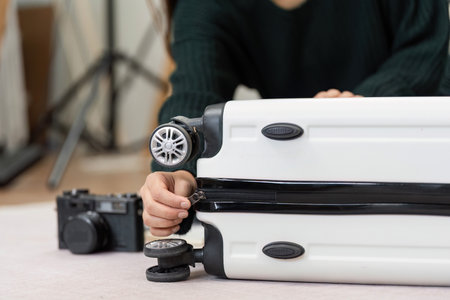 Zipping a suitcase after packing during travel preparation