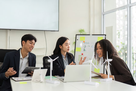 Collaborative ESG Strategy Discussion. Team members evaluate sustainable practices and strategies in...