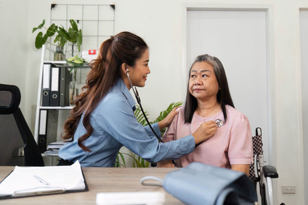 Healthcare and Elderly Care. Compassionate medical professional conducting a routine checkup for an elderly patient.の写真素材
