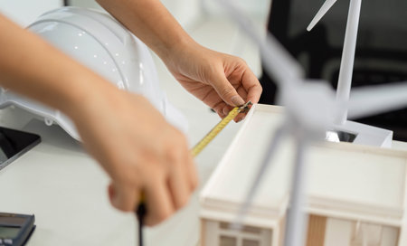 Precision in Architecture. Professional measuring a model for sustainable design.の写真素材