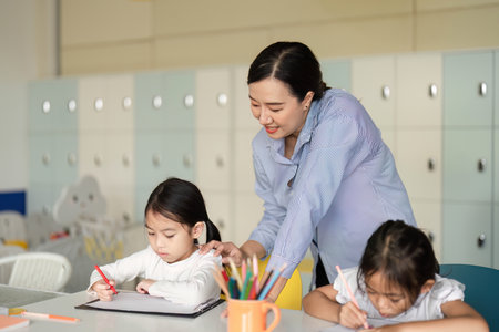 Back to School. Teacher guiding students in a creative learning activity.