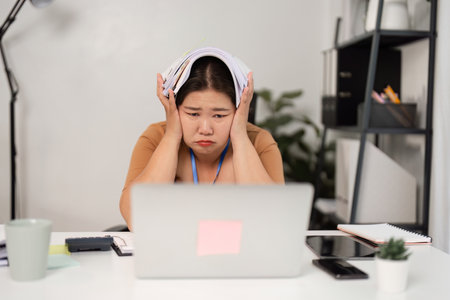 Stressed Businesswoman Overwhelmed with Workload in Modern Office Setting