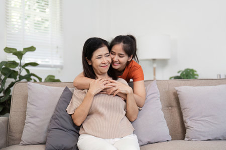 Heartwarming Moment of Mother and Child Embracing on Hug Day in a Cozy Home Settingの写真素材