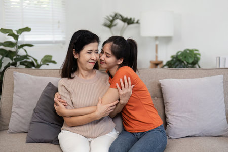 Heartwarming Moment of Mother and Child Embracing on Hug Day in a Cozy Home Settingの写真素材