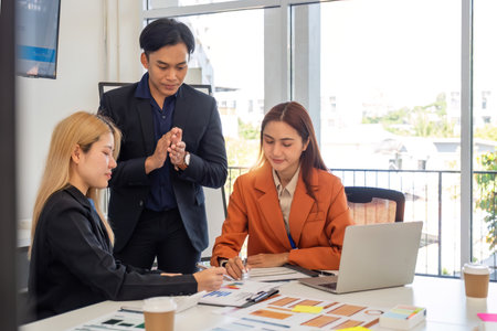 Collaborative Business Strategy. Professionals brainstorming financial solutions in office.の写真素材