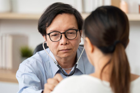 Doctor Using Stethoscope for Patient Checkup. Physician examining patient with a stethoscope.の写真素材
