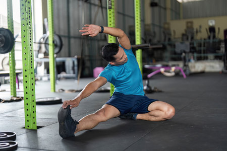 Fitness and Flexibility. Man stretching his side in a gym for improved mobility.