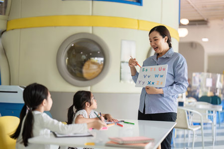 Back to School. Teacher demonstrating letters to students in a dynamic classroom.