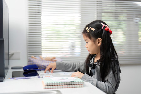 Creative Playtime. A focused girl engaged in an arts and crafts activity at home.の写真素材